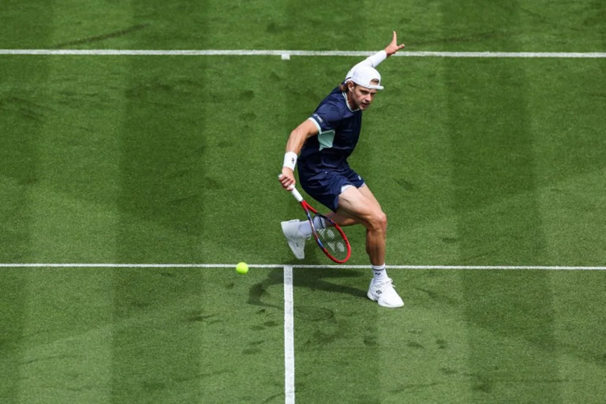 Belgium's Zizou Bergs plays a forehand return to Brazil's Joao Fonseca during their men's singles tennis match on day one at the Lexus Eastbourne International tennis tournament in Eastbourne, southern England, on June 23, 2025. Adrian Dennis / AFP