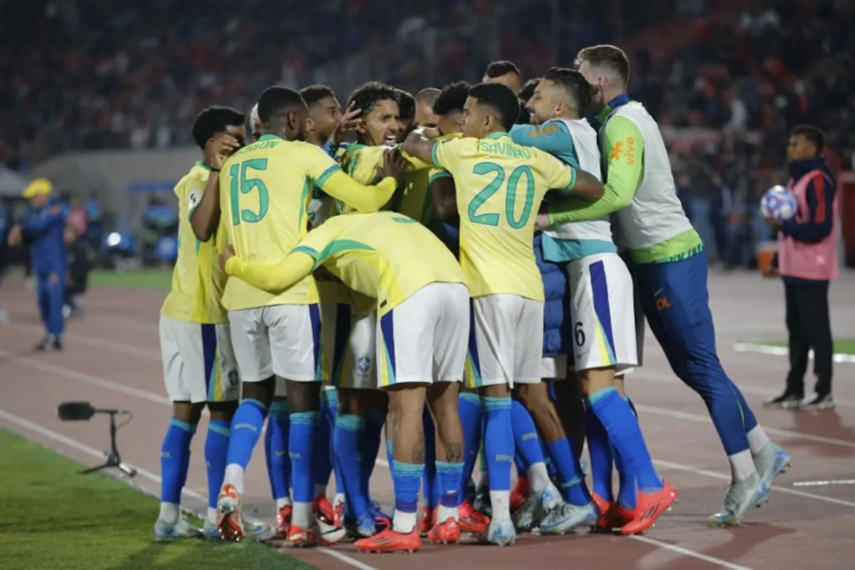 Brazil's forward Luiz Henrique (unseen) celebrates with teammates after scoring during the 2026 FIFA World Cup South American qualifiers football match between Chile and Brazil, at the National stadium in Santiago, on October 10, 2024.  Javier TORRES / AFP