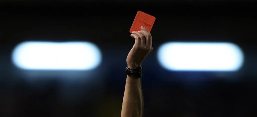 The hand of Argentine referee Diego Abal showing the red card to Rosario Central's defender Lucas Acevedo (not in frame) during their Copa Sudamericana 2014 second round second leg football match against Boca Juniors at the Bombonera stadium in Buenos Aires, Argentina, on September 18, 2014. AFP PHOTO / Juan Mabromata Juan MABROMATA / AFP