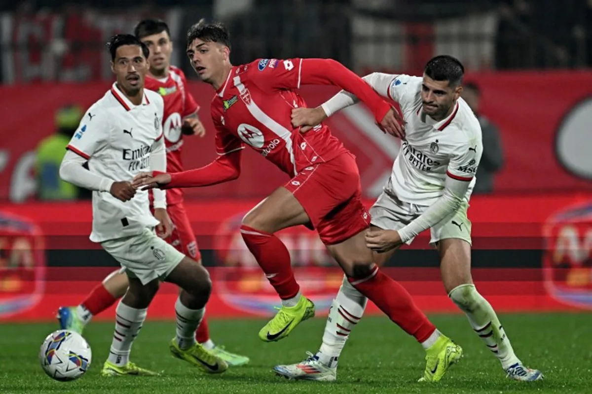 (From L) AC Milan's Dutch midfielder #14 Tijani Reijnders, Monza's Italian midfielder #14 Daniel Maldini and AC Milan's Spanish forward #07 Alvaro Morata fight for the ball during the Italian Serie A football match between AC Monza and AC Milan at the Brianteo stadium in Monza, on November 2, 2024.  GABRIEL BOUYS / AFP