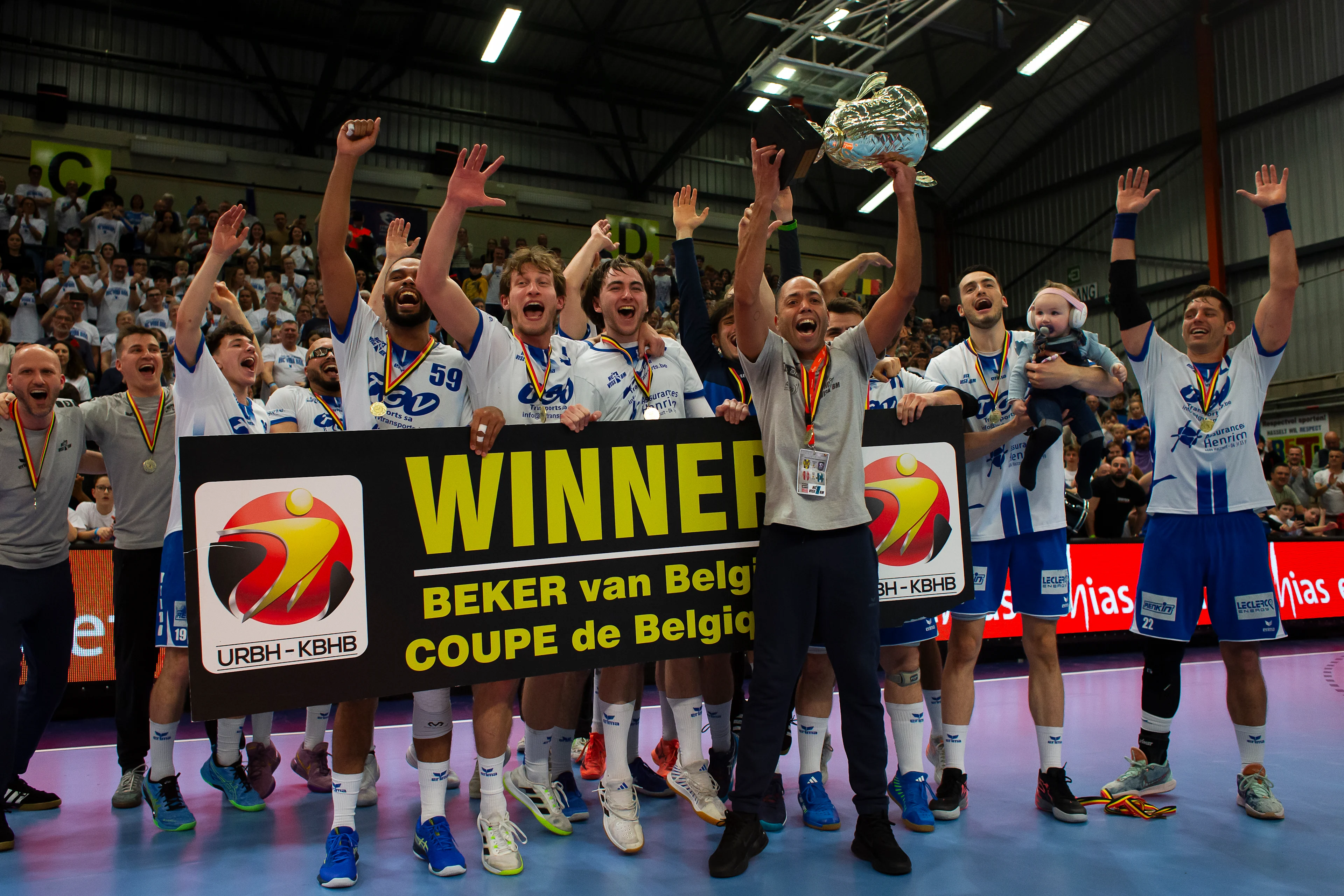 HC Vise BM players and staff celebrate after winning a game between KTSV Eupen and HC Vise BM, Saturday 30 March 2024, in Hasselt, the men's final of the Belgian handball cup. BELGA PHOTO KRISTOF VAN ACCOM