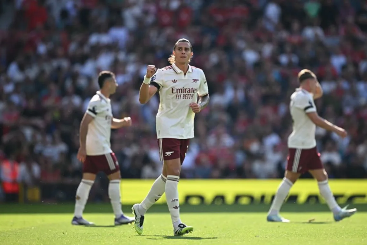 Arsenal's Italian defender #33 Riccardo Calafiori (C) celebrates scoring the opening goal during the English Premier League football match between Manchester United and Arsenal at Old Trafford in Manchester, north west England, on August 17, 2025. Paul ELLIS / AFP