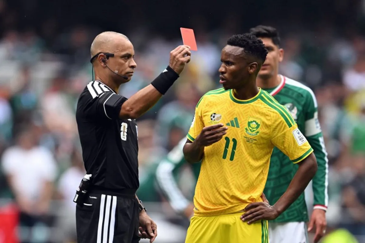 Brazilian referee Wilton Sampaio shows a red card to South Africa's midfielder #11 Themba Zwane during the 2026 World Cup Group A football match between Mexico and South Africa at the Mexico City Stadium in Mexico City on June 11, 2026. Yuri CORTEZ / AFP