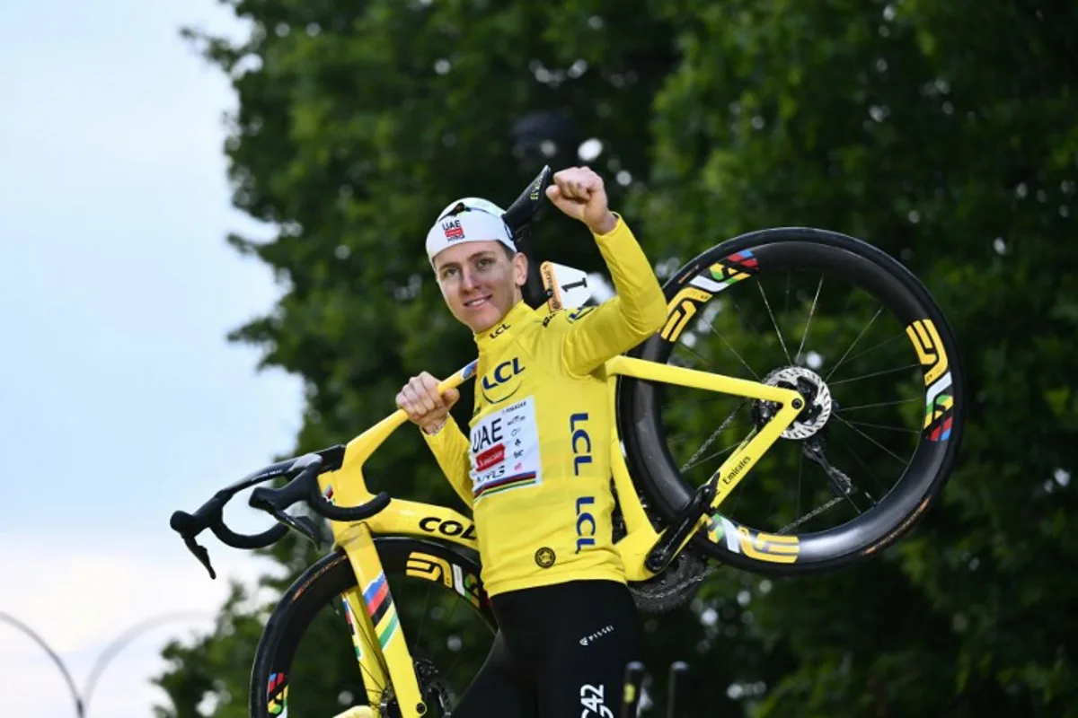 UAE Team Emirates - XRG team's Slovenian rider Tadej Pogacar celebrates on the podium with the overall leader's yellow jersey after the 21st and final stage of the 112th edition of the Tour de France cycling race, 132.3 km between Mantes-la-Ville and Paris Champs-Élysees, on July 27, 2025. Marco BERTORELLO / AFP