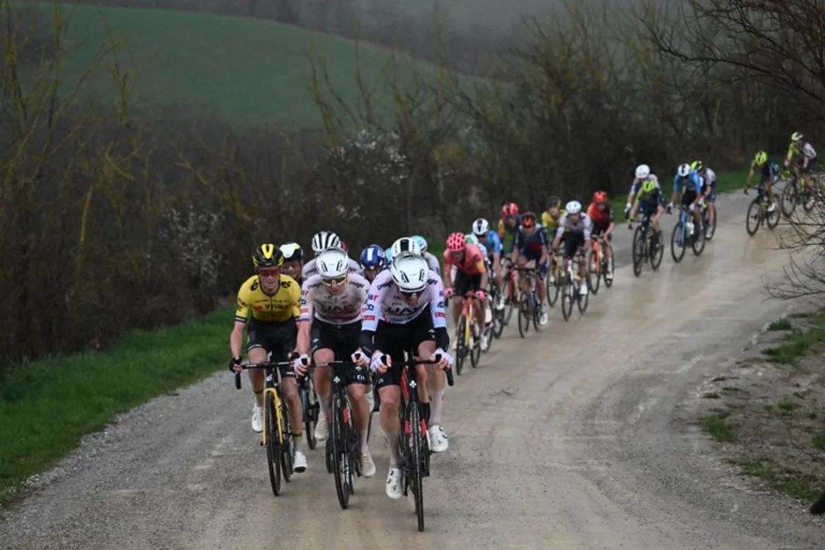 US Sepp Kuss (L), team Visma and Slovenian Tadej Pogacar (2ndL), team UAE lead the race during the 18th one-day classic 'Strade Bianche' (White Roads) cycling race between Siena and Siena, Tuscany, on March 2, 2024.  Marco BERTORELLO / AFP