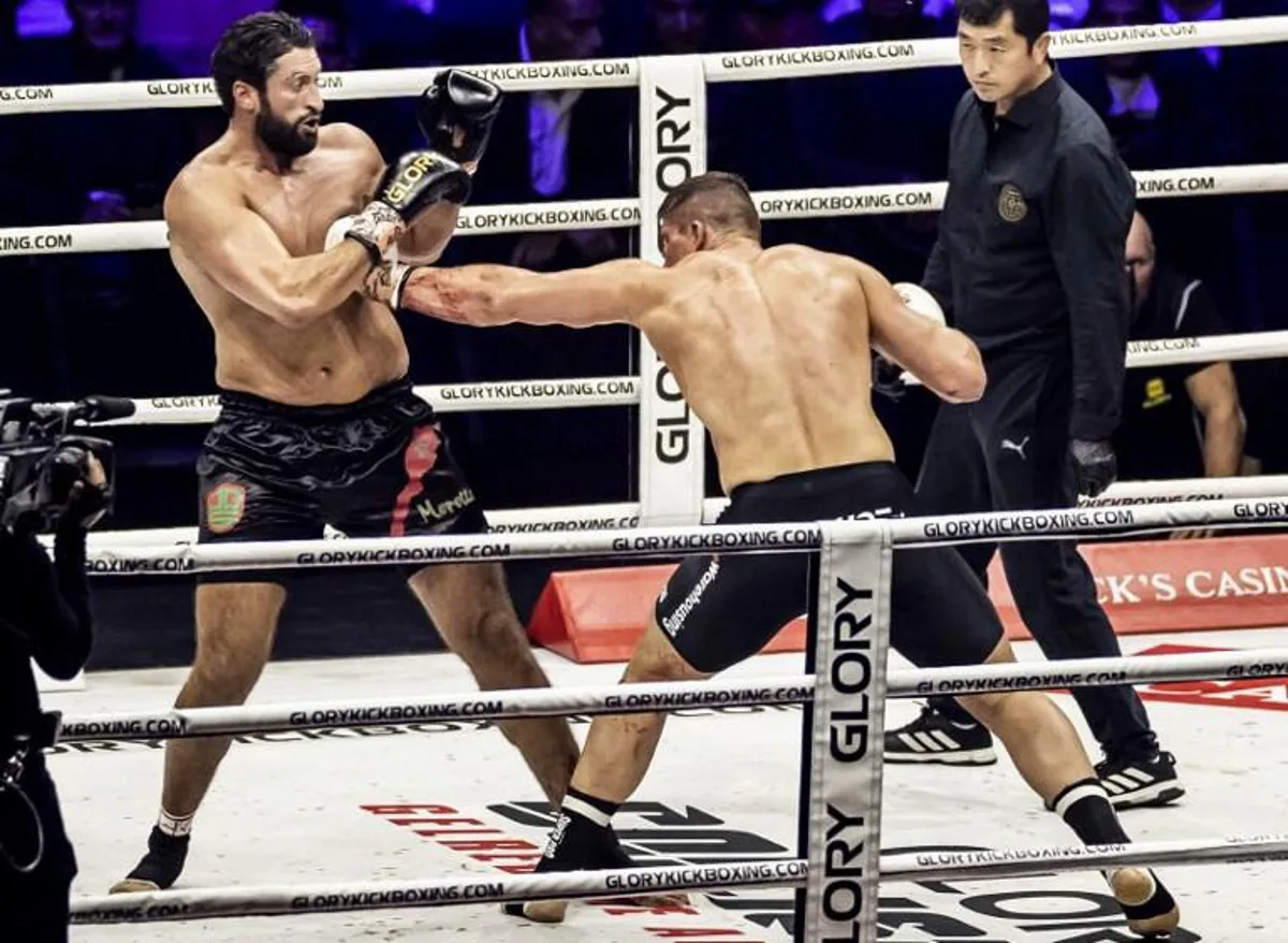 Dutch kickboxer Rico Verhoeven (R) hits Belgium-Moroccan Jamal Ben Saddik (L) during their heavyweight world title fight at the Gelredome in Arnhem on October 23, 2021.  Remko de Waal / ANP / AFP Netherlands OUT

