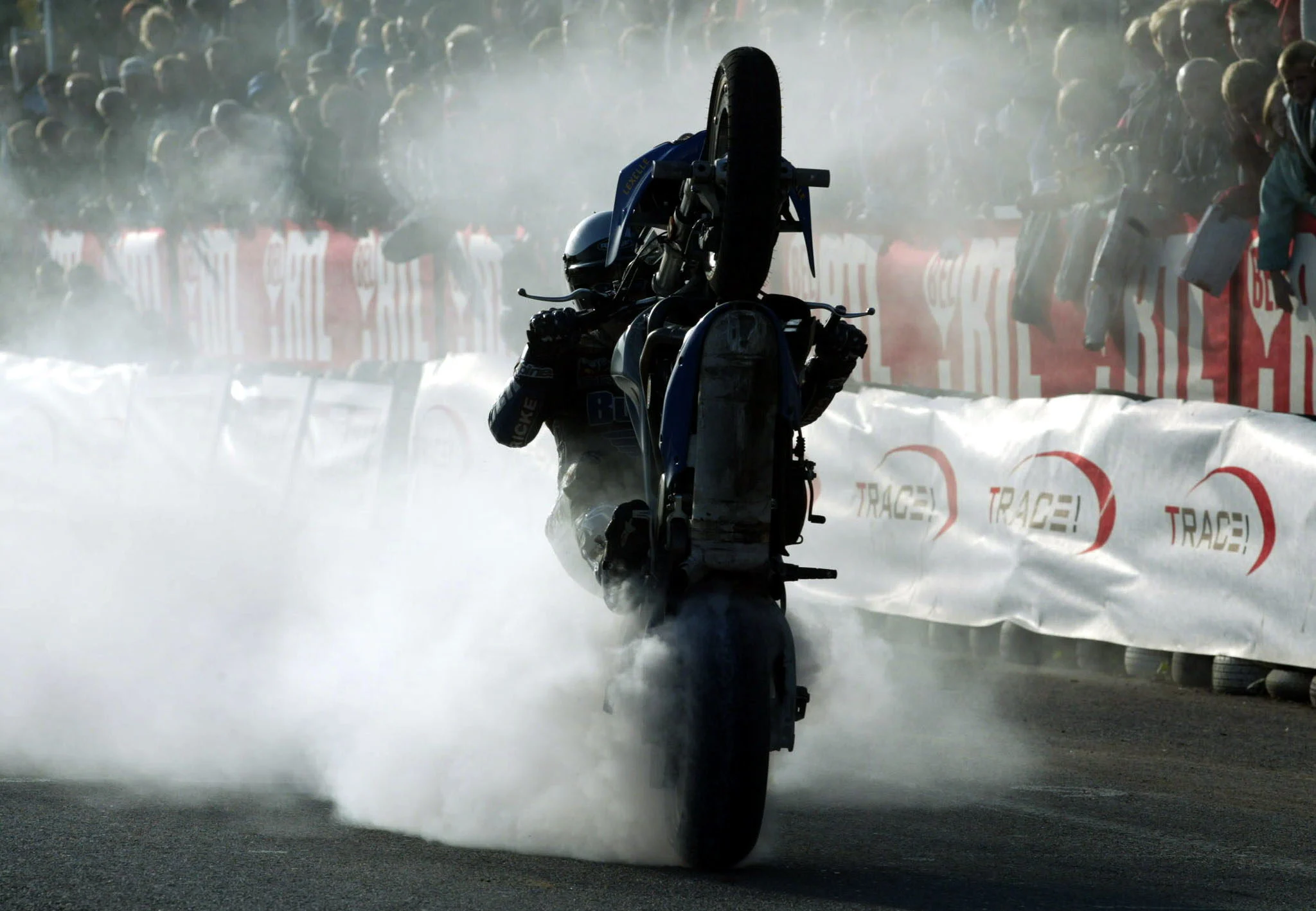 BRU199 - 20031012 - METTET, BELGIUM : Illustration picture shows a pilot making smoke during a burn-put wheelie at the Superbiker Grand Prix of Mettet, Sunday 12 October 2003, in Mettet. BELGA PHOTO JOHN THYS