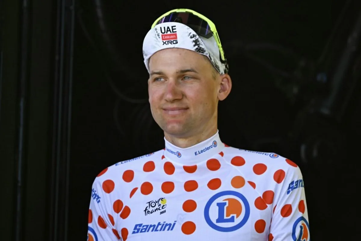 UAE Team Emirate - XRG team's Belgian rider Tim Wellens celebrates on the podium with the best climber's polka dot (dotted) jersey after the 7th stage of the 112th edition of the Tour de France cycling race, 197 km between Saint-Malo and Mur-de-Bretagne Guerledan, in Brittany, western France, on July 11, 2025. Loic VENANCE / AFP