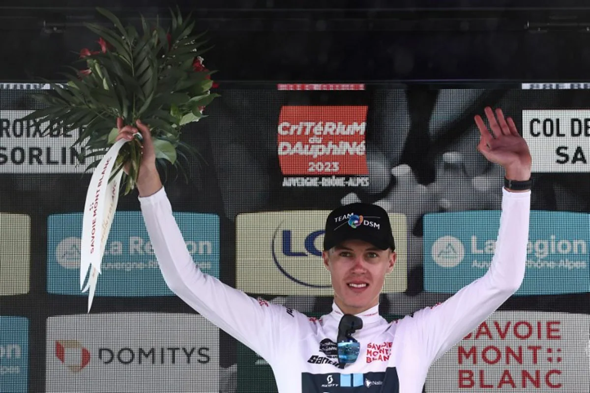 Team DSM's British rider Max Poole celebrates on the podium with the white jersey of overall best young during the seventh stage of the 75th edition of the Criterium du Dauphine cycling race, 148km between Port de Savoie to Col de la Croix de Fer - Saint Sorlin, France, on June 10, 2023.  Anne-Christine POUJOULAT / AFP