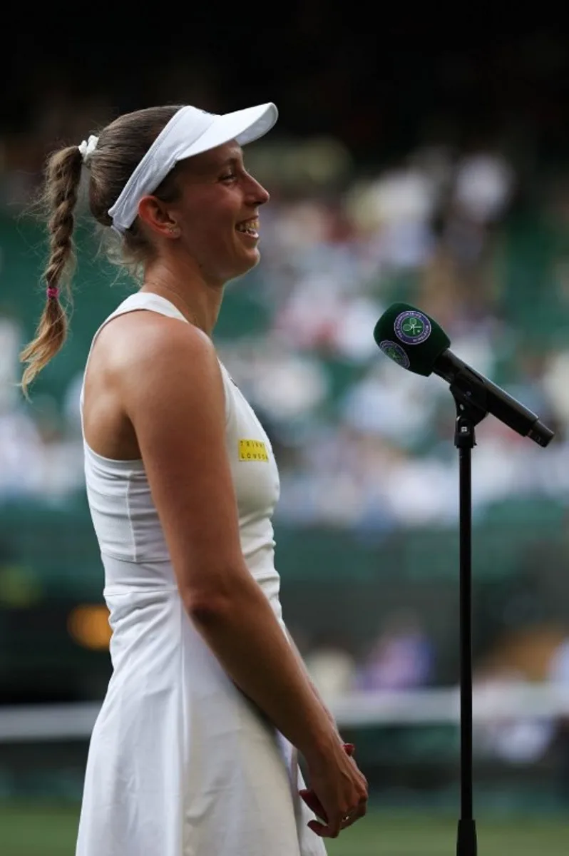 Belgium's Elise Mertens speaks to the audience after her victory over Ukraine's Elina Svitolina at the end of their women's singles third round tennis match on the fifth day of the 2025 Wimbledon Championships at The All England Lawn Tennis and Croquet Club in Wimbledon, southwest London, on July 4, 2025. Adrian Dennis / AFP