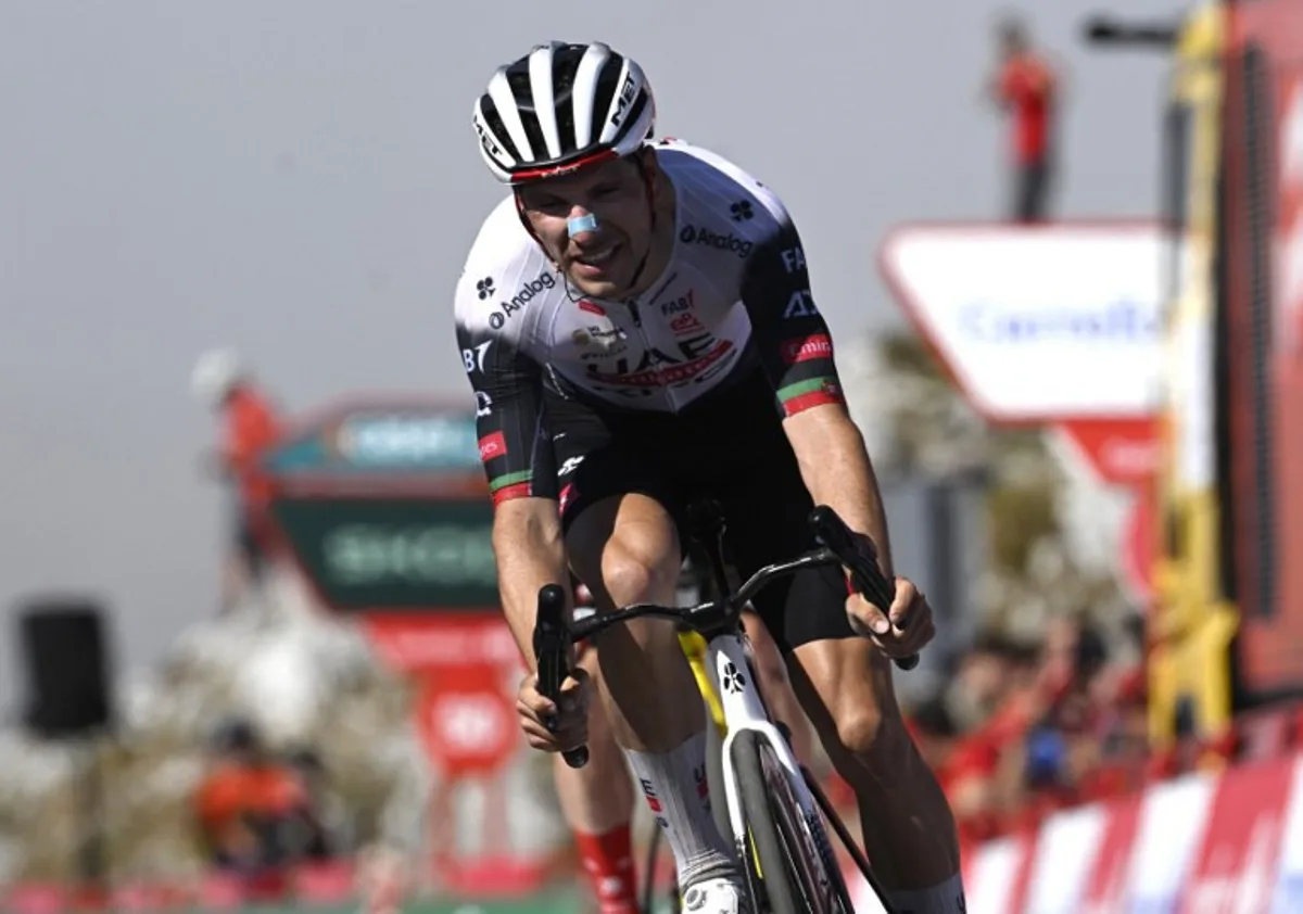 Team UAE's Portuguese rider Joao Almeida crosses first the finish line of the 13th stage of the Vuelta a Espana, a 202 km race between Cabezon de la Sal and L'Angliru, on September 5, 2025. Miguel RIOPA / AFP