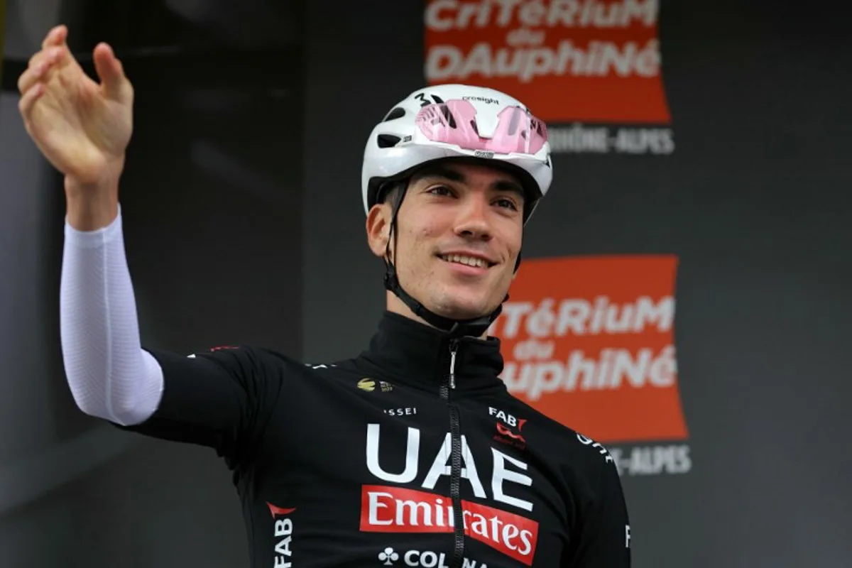 Team UAE's Spanish rider Juan Ayuso waves before the start of the second stage of the 76th edition of the Criterium du Dauphine cycling race, 142km between Gannat and Col de la Loge, near La Chamba, central France, on June 3, 2024.  Thomas SAMSON / AFP