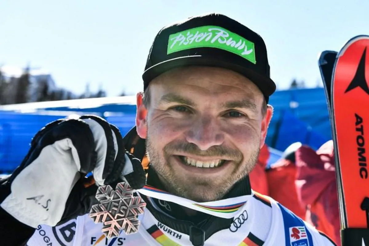 Second-placed Germany's Andreas Sander celebrates after the medal ceremony after competing in the Men's Downhill on February 14, 2021 during the FIS Alpine World Ski Championships in Cortina d'Ampezzo, Italian Alps.   Fabrice COFFRINI / AFP