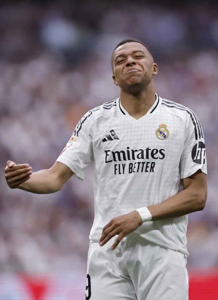 Real Madrid's French forward #09 Kylian Mbappe reacts during the Spanish league football match between Real Madrid CF and Real Sociedad at Santiago Bernabeu Stadium in Madrid on May 24, 2025. OSCAR DEL POZO / AFP