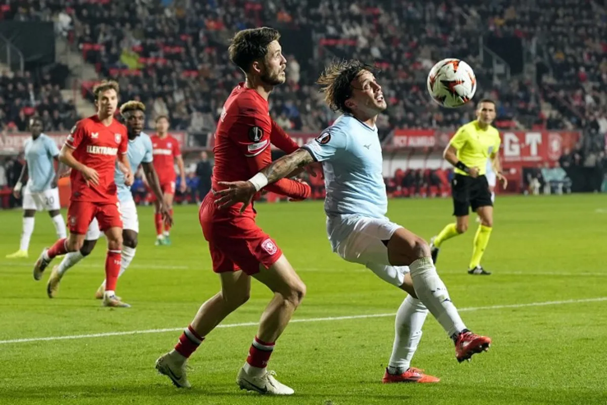 FC Twente's Dutch forward #09 Ricky van Wolfswinkel (CL) and Lazio's Italian defender #03 Luca Pellegrini (CR) fight for the ball during the UEFA Europa League, League Phase - Matchday 3, football match between FC Twente Enschede and SS Lazio at the FC Twente Stadium on October 24, 2024.  Tobias Kleuver / ANP / AFP