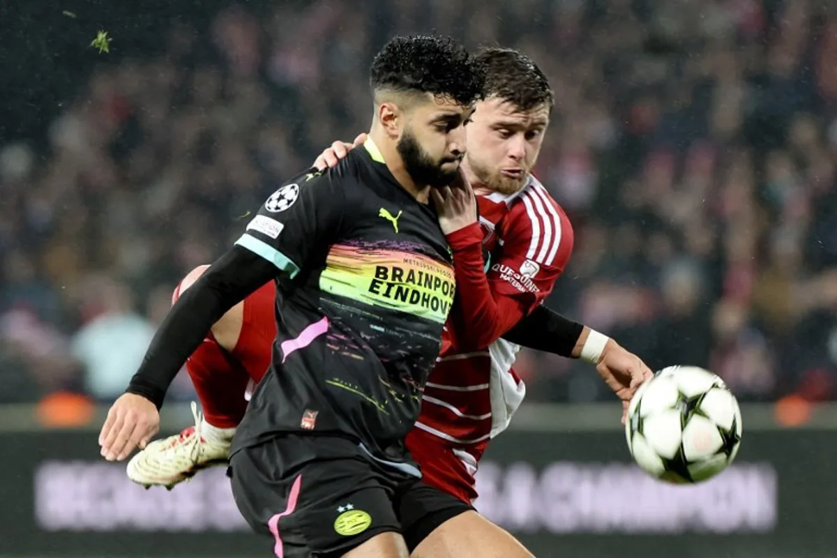 PSV Eindhoven's Moroccan midfielder #34 Ismael Saibari (L) fights for the ball with Brest's French midfielder #08 Hugo Magnetti (R) during the UEFA Champions League phase - Matchday 6, football match between Stade Brestois 29 (Brest) and PSV Eindhoven at the Roudourou Stadium in Guingamp, north-western France, on December 10, 2024.  FRED TANNEAU / AFP