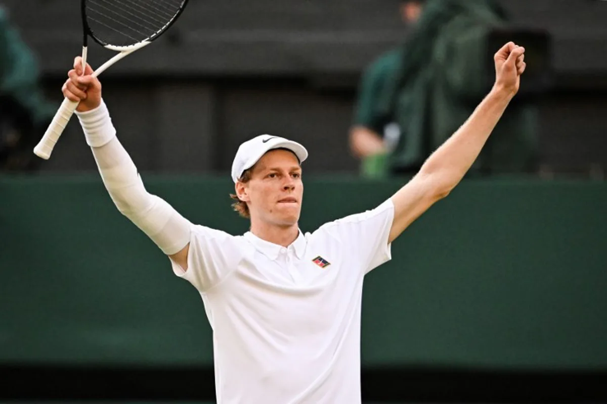 Italy's Jannik Sinner celebrates after victory against Spain's Carlos Alcaraz at the end of their men's singles final tennis match on the fourteenth day of the 2025 Wimbledon Championships at The All England Lawn Tennis and Croquet Club in Wimbledon, southwest London, on July 13, 2025.  Kirill KUDRYAVTSEV / AFP