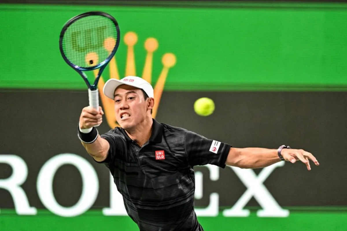 Japan's Kei Nishikori hits a return against Argentina's Mariano Navone during their men's singles match at the Shanghai Masters tennis tournament in Shanghai on October 2, 2024.  Hector RETAMAL / AFP