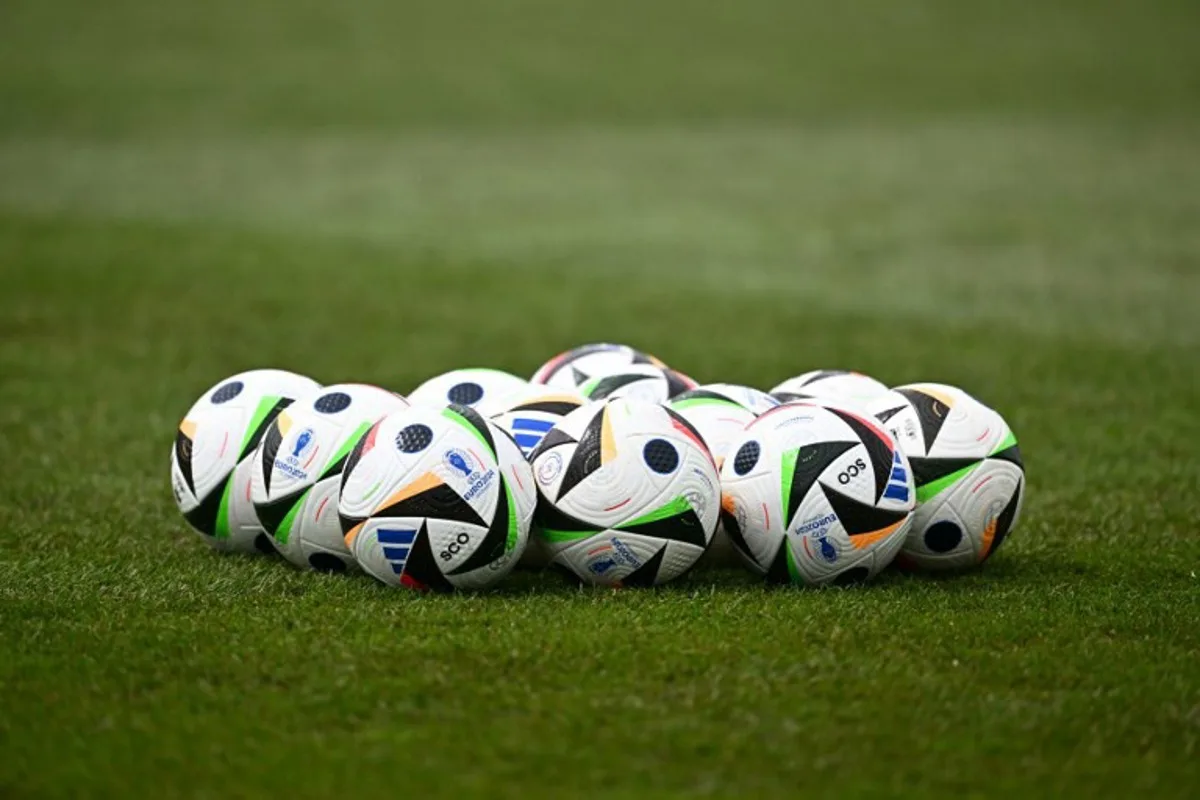 Soccer balls are pictured on the pitch prior to the MD-1 training session of Scotland's national football team ahead of the UEFA Euro 2024 football Championship at the team's base camp in Garmisch-Partenkirchen on June 13, 2024.  Fabrice COFFRINI / AFP