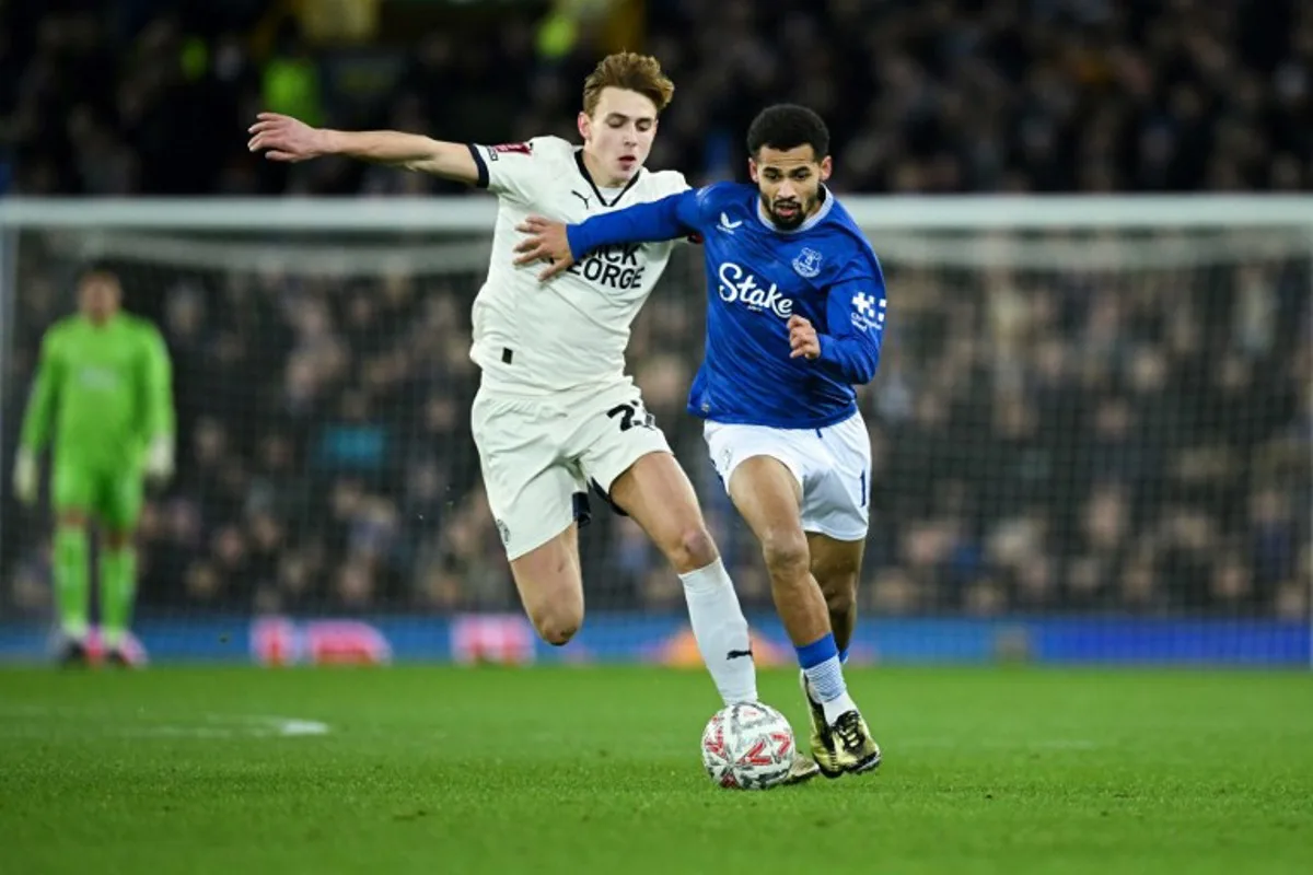 Peterborough's Cypriot midfielder #22 Hector Kyprianou (L) fights for the ball with Everton's Senegalese striker #10 Iliman Ndiaye during the English FA Cup third round football match between Everton and Peterborough United at Goodison Park in Liverpool, north west England on January 9, 2025.  Oli SCARFF / AFP