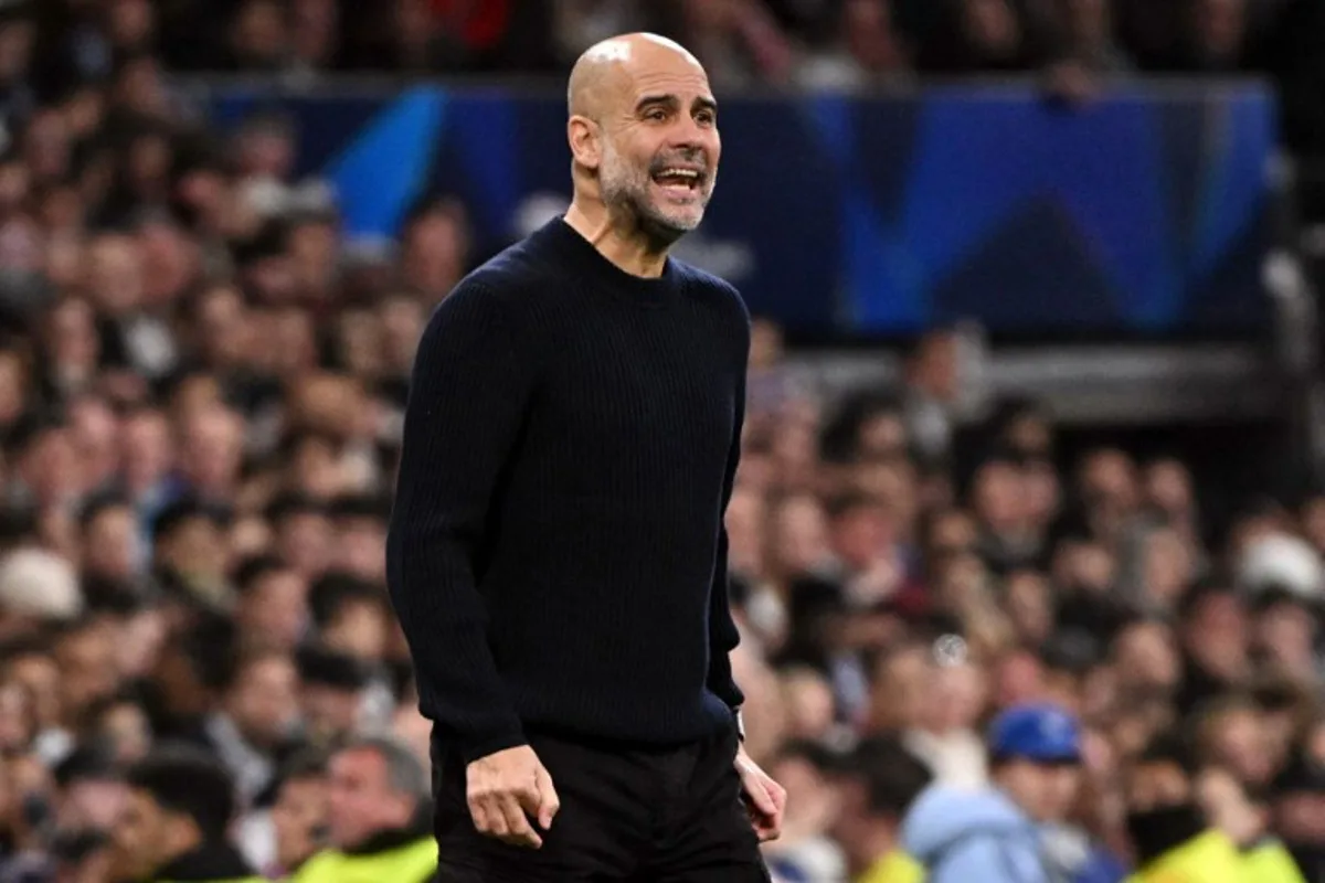 Manchester City's Spanish coach Pep Guardiola shouts instructions to his players during the UEFA Champions League knockout phase play-off football match between Real Madrid CF and Manchester City at the Santiago Bernabeu stadium in Madrid on February 19, 2025.  JAVIER SORIANO / AFP