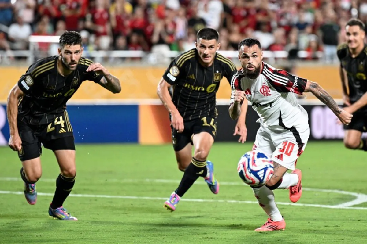 (From L) LAFC's US defender #24 Ryan Hollingshead, LAFC's Spanish defender #14 Sergi Palencia and Flamengo's Brazilian forward #30 Michael fight for the ball during the FIFA Club World Cup 2025 Group D football match between US Los Angeles FC and Brazil's CR Flamengo at the Camping World stadium in Orlando on June 24, 2025. PATRICIA DE MELO MOREIRA / AFP