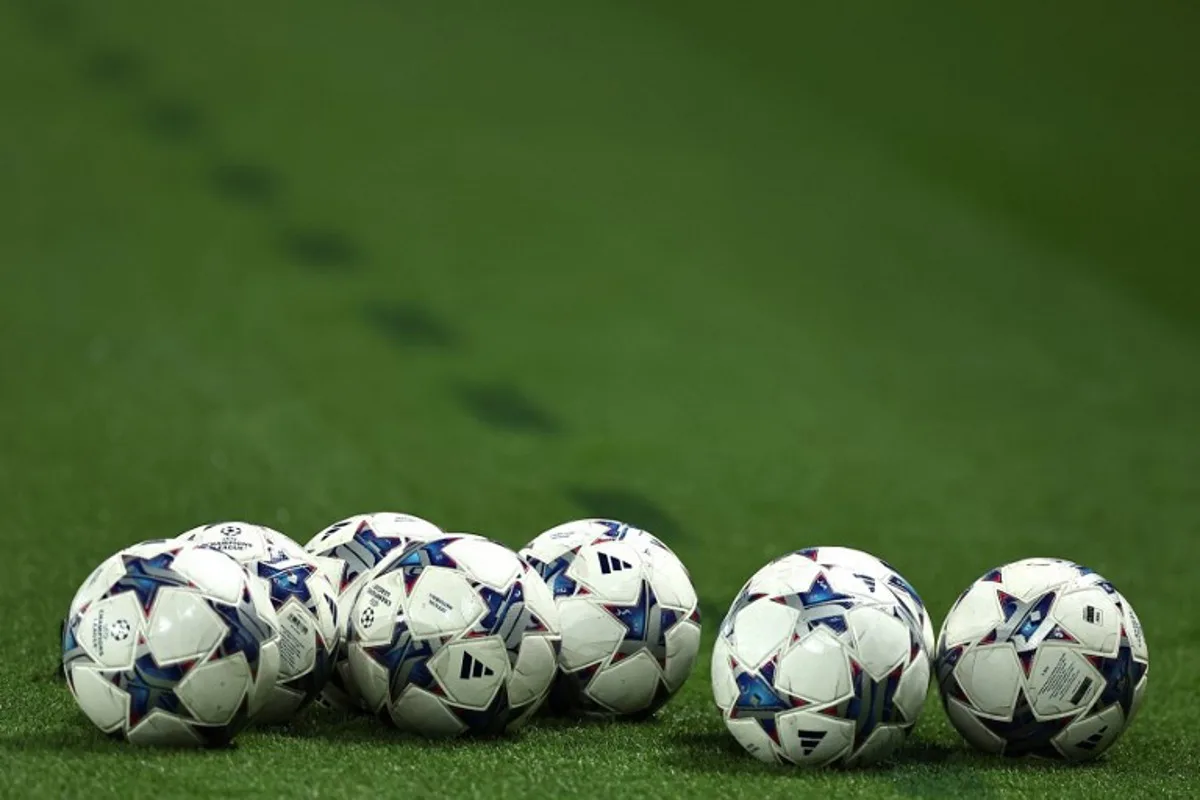 This photograph taken in Paris on October 25, 2023 shows UEFA Champions League's balls on the pitch prior to the UEFA Champions League Group F football match between Paris Saint-Germain (PSG) and AC Milan at the Parc de Princes.  FRANCK FIFE / AFP