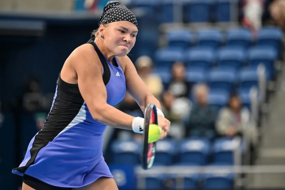 Russia's Diana Shnaider hits a return against China's Zheng Qinwen during their women's singles semifinal match on day six of the Pan Pacific Open tennis tournament in Tokyo on October 26, 2024.   Richard A. Brooks / AFP