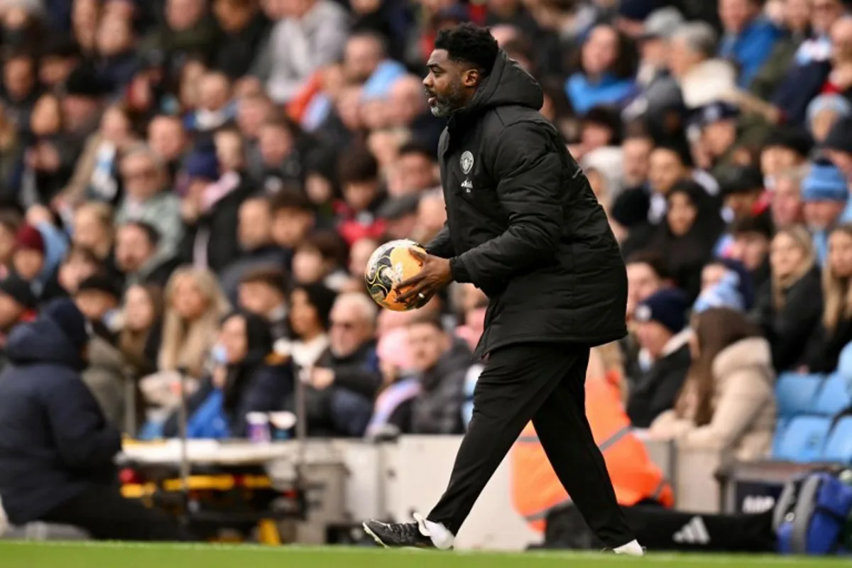 Manchester City's Ivorian assistant coach Kolo Touré holds the ball during the English FA Cup third round football match between Manchester City and Salford City at the Etihad Stadium in Manchester, north west England, on February 14, 2026. Oli SCARFF / AFP