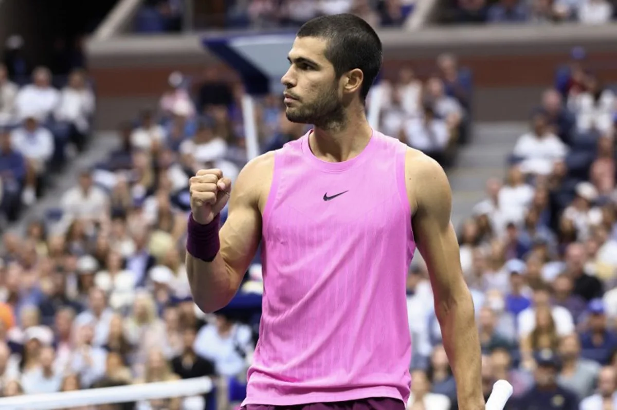 Spain's Carlos Alcaraz celebrates after a point against Italy's Jannik Sinner during the men's singles final tennis match on day fifteen of the US Open tennis tournament at the USTA Billie Jean King National Tennis Center in New York City on September 7, 2025. CHARLY TRIBALLEAU / AFP