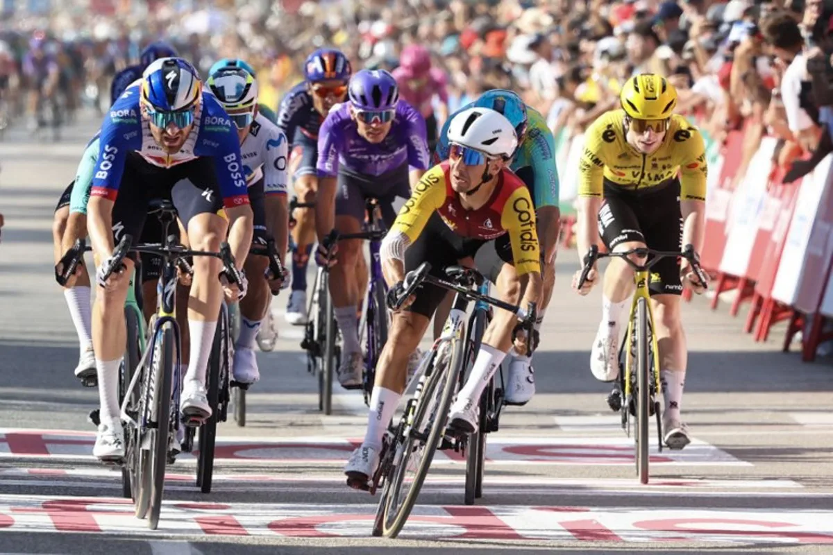 Team Cofidis' French rider Bryan Coquard (C) crosses the finish line to win the eighth stage of the Vuelta a Espana 2026, a 171 km race between Pucol and Xeraco on August 29, 2026. Josep LAGO / AFP