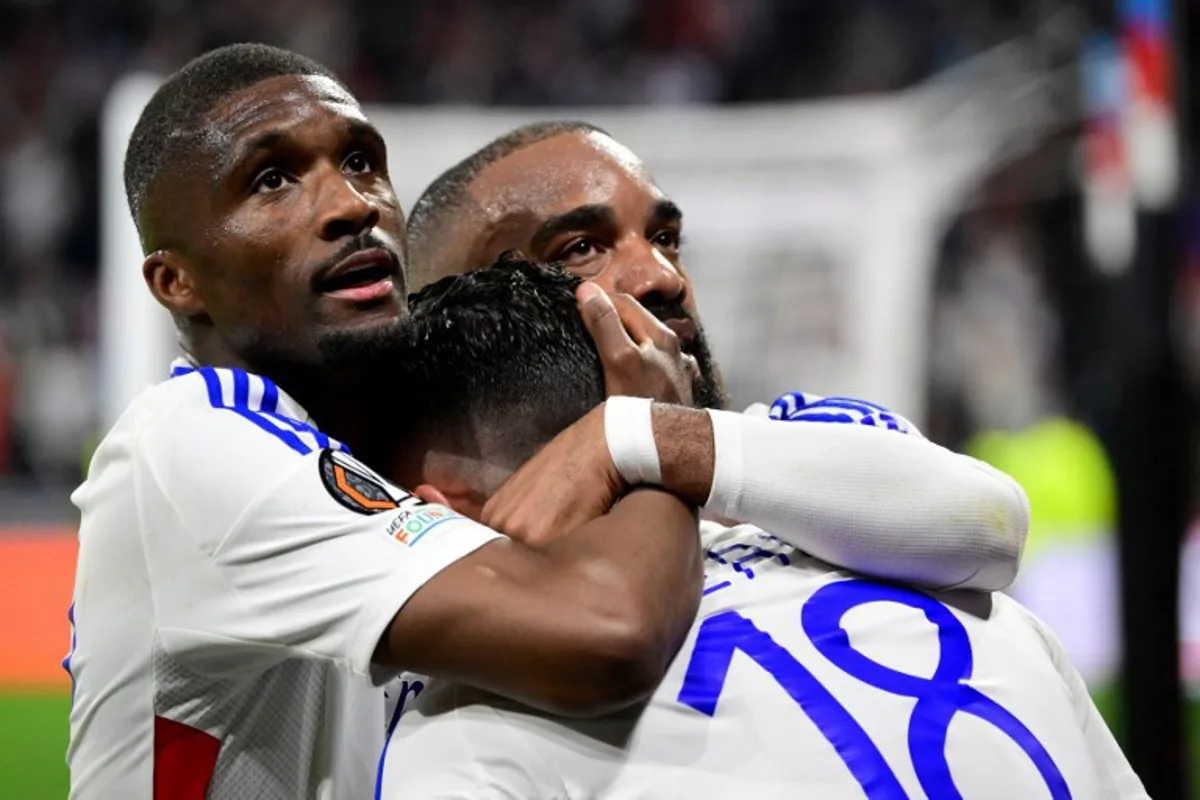 Lyon's French midfielder #18 Rayan Cherki celebrates, with Lyon's Angolan defender #22 Clinton Mata (L) and Lyon's French forward #10 Alexandre Lacazette, scoring his team's second goal during the UEFA Europa League Quarter final first leg football match between Olympique Lyonnais (OL) and Manchester United at the Parc Olympique Lyonnais Groupama stadium in Decines-Charpieu, central-eastern France, on April 10, 2025. Olivier CHASSIGNOLE / AFP