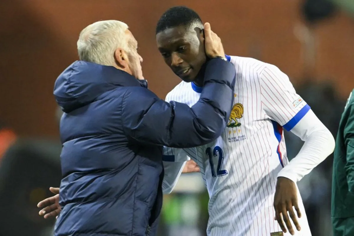 France's head coach Didier Deschamps embraces France's forward #12 Randal Kolo Muani as he substitutes during the UEFA Nations League League A, Group A2 football match between Belgium and France, at the King Baudouin Stadium in Brussels, on October 14, 2024.  NICOLAS TUCAT / AFP