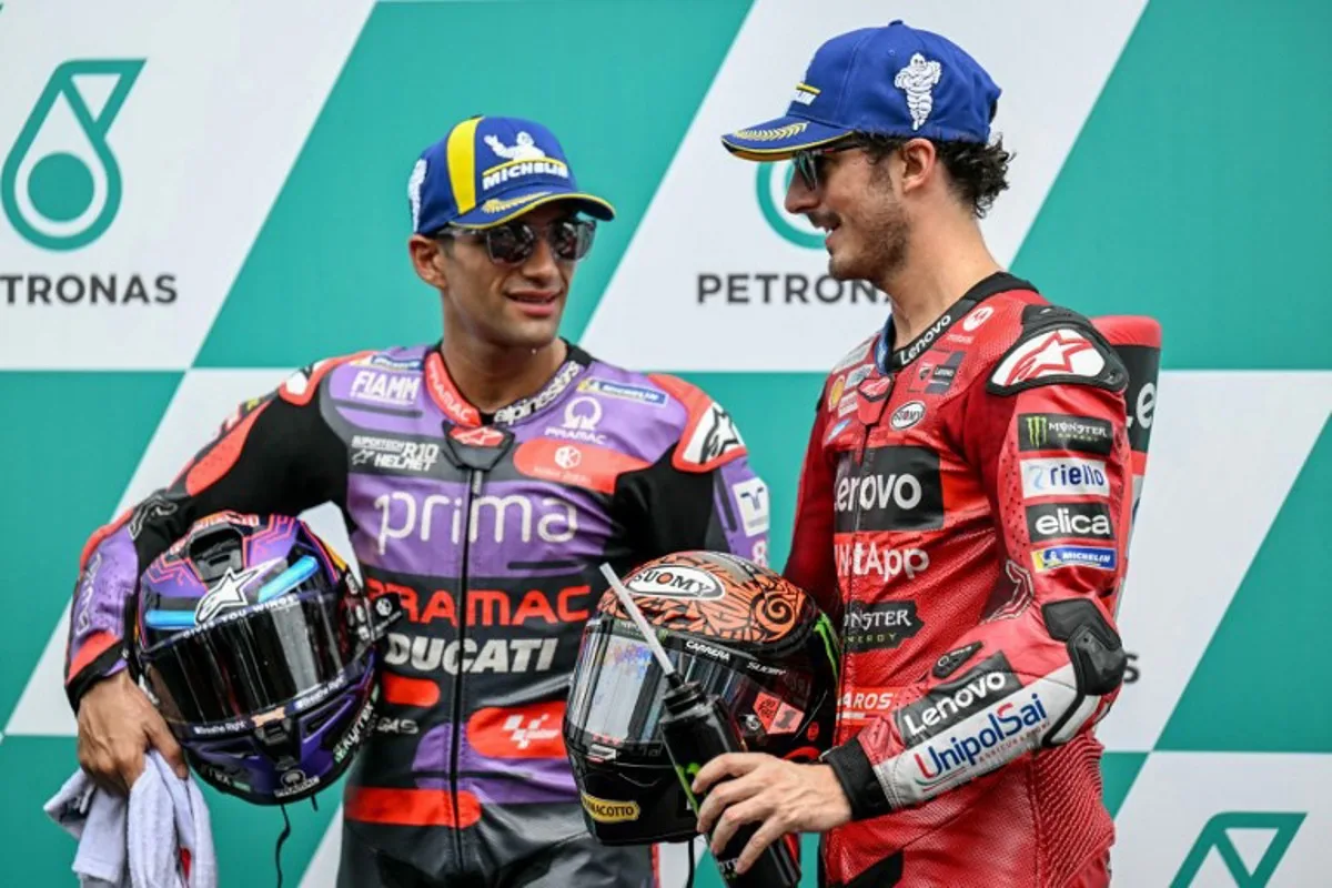 Ducati Lenovo Team's Italian rider Francesco Bagnaia (R) in pole position speaks with second placed Prima Pramac Racing's Spanish rider Jorge Martin (L) after the qualifying session of the MotoGP Malaysian Grand Prix at the Sepang International Circuit in Sepang on November 2, 2024.  MOHD RASFAN / AFP