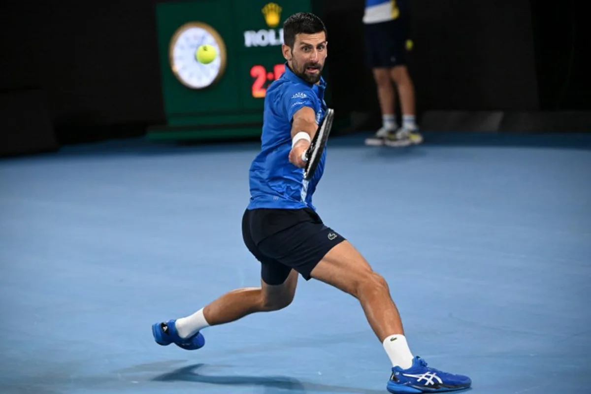 Serbia's Novak Djokovic hits a return against Portugal's Jaime Faria during their men's singles match on day four of the Australian Open tennis tournament in Melbourne on January 15, 2025.  WILLIAM WEST / AFP