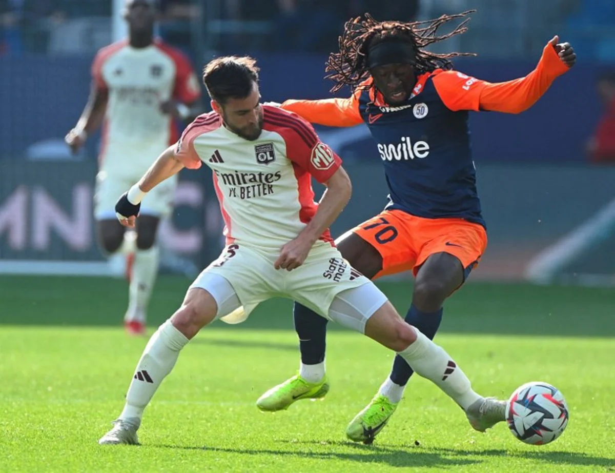 Montpellier's French forward #70 Tanguy Coulibaly (R) vies with Lyon's Argentine defender #03 Nicolas Tagliafico (L) during the French L1 football match between Montpellier Herault SC and Olympique Lyonnais (OL) at the Stade de la Mosson in Montpellier, southern France, on February 16, 2025.  Sylvain THOMAS / AFP