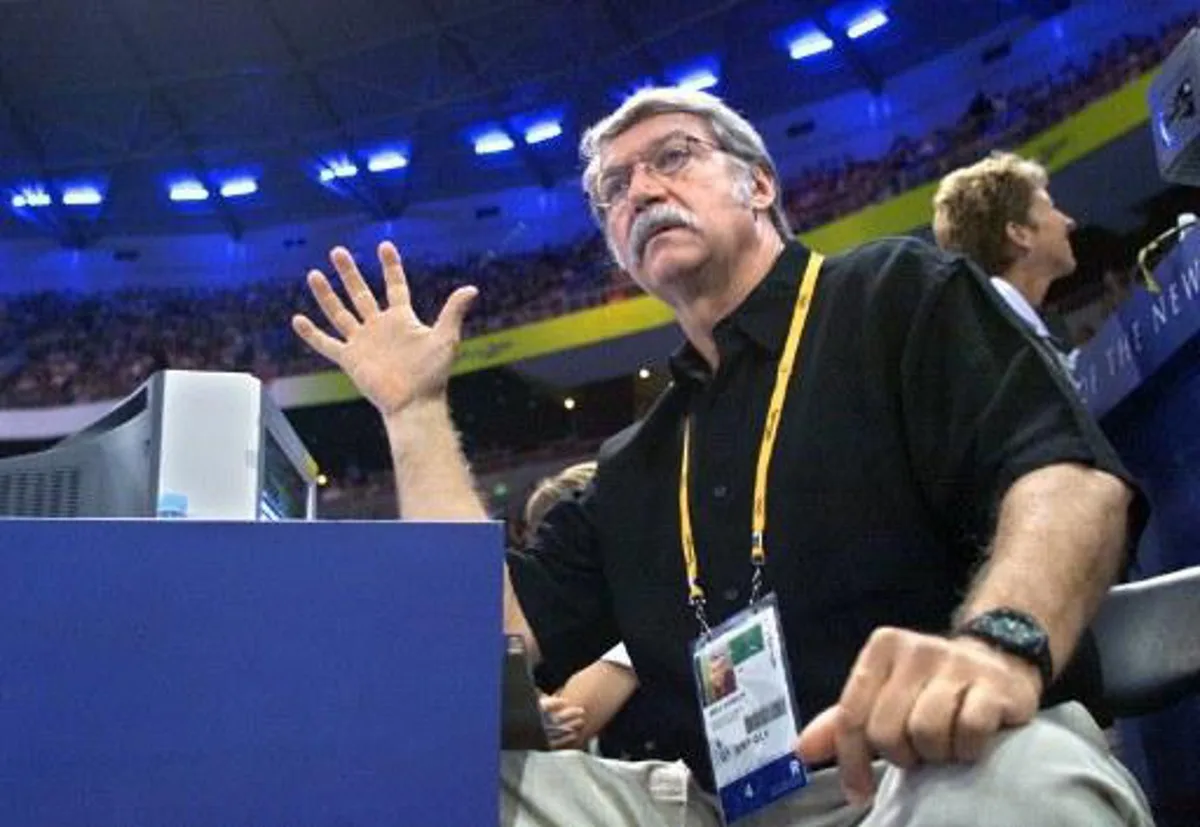 USA team coordinator Bela Karolyi gestures from the stands, 19 September 2000 at the SuperDome, during the gymnastics women's team finals at the Sydney 2000 Olympic Games. Karolyi was banished from the gymnastics competition area 14 Septemberand sentenced to sit in the stands for the first time in his eight trips to the Olympics after criticizing the Sydney organizing committee a day before the opening ceremony. AFP PHOTO / Frederic J. BROWN