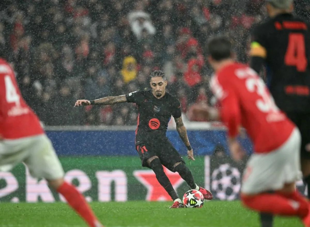 Barcelona's Brazilian forward #11 Raphinha kicks the ball during the UEFA Champions League, league phase football match between SL Benfica and FC Barcelona at Luz stadium in Lisbon on January 21, 2025.  PATRICIA DE MELO MOREIRA / AFP