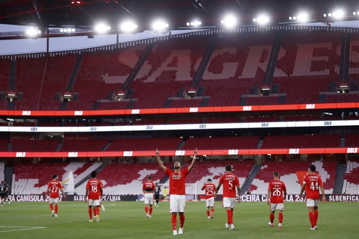 Benfica's Greek forward #14 Vangelis Pavlidis (C) celebrates scoring the opening goal during the Portuguese League football match between SL Benfica and Academico de Viseu FC at Estadio da Luz in Lisbon on August 9, 2026.  FILIPE AMORIM / AFP