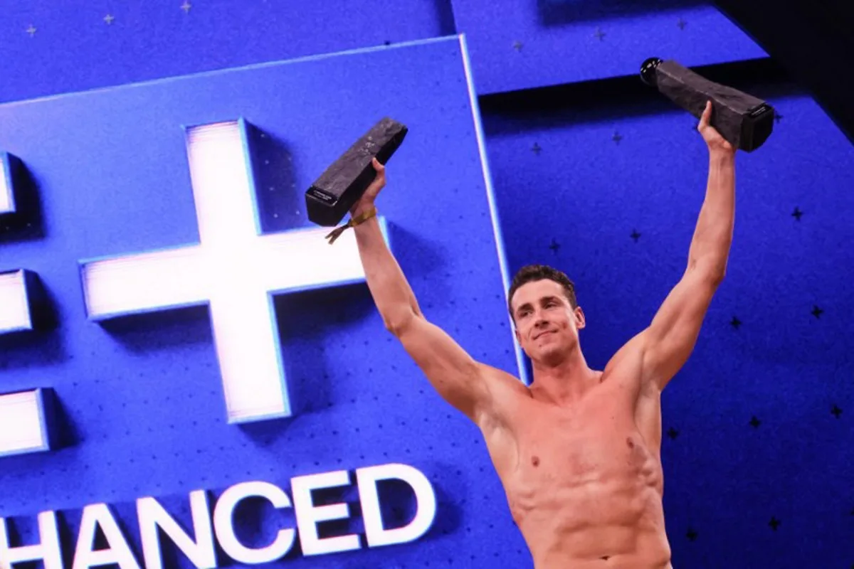 Greek swimmer Kristian Gkolomeev celebrates his wins during the medal ceremony following the Enhanced Games at Resorts World Las Vegas in Las Vegas, Nevada, on May 24, 2026. The first-ever Enhanced Games -- widely dubbed the "Steroid Olympics" -- take place Sunday in Las Vegas, where elite sprinters, swimmers and weightlifters will vie for world records while taking banned performance-enhancing drugs. ETIENNE LAURENT / AFP