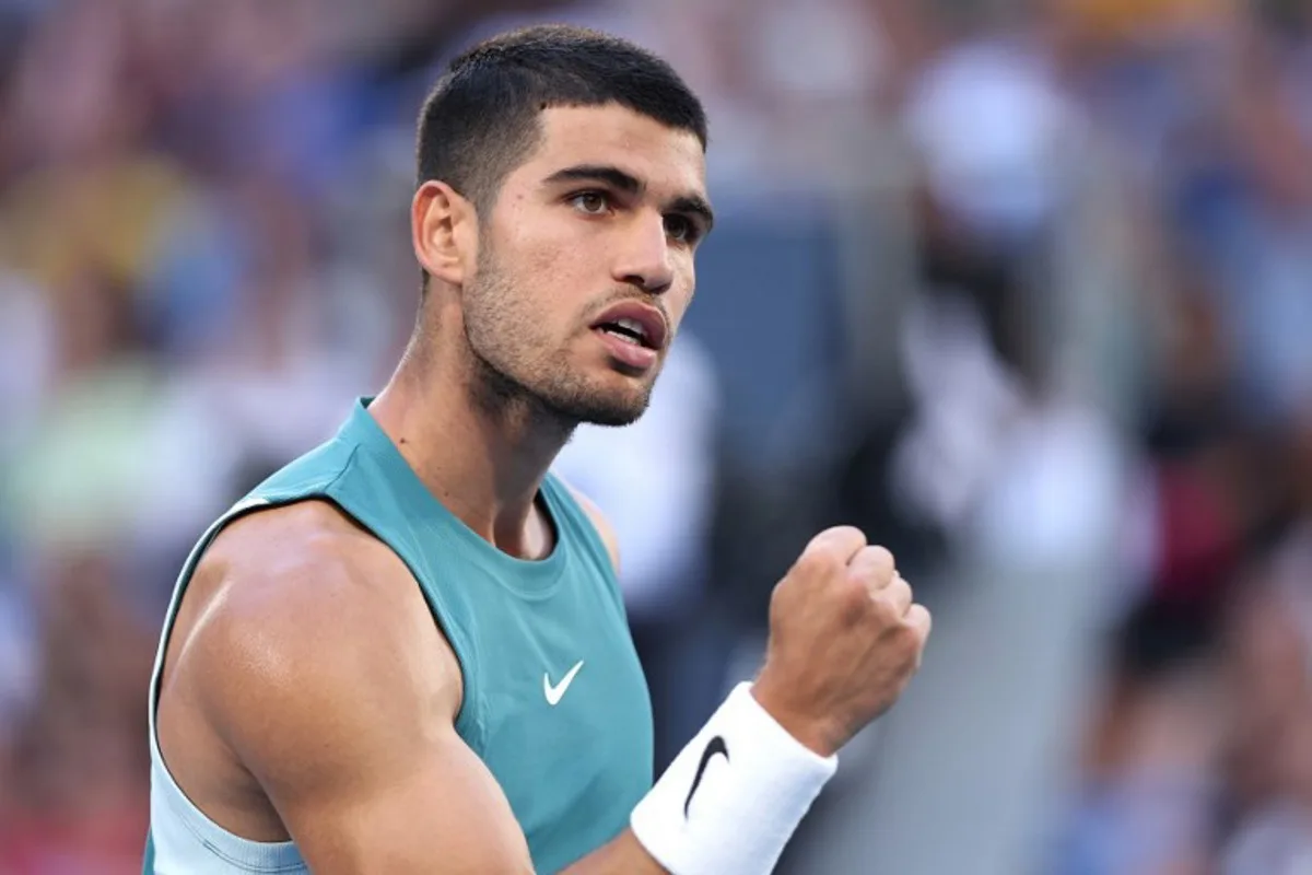 Spain's Carlos Alcaraz reacts on a point against Kazakhstan's Alexander Shevchenko during their men's singles match on day two of the Australian Open tennis tournament in Melbourne on January 13, 2025.  Martin KEEP / AFP