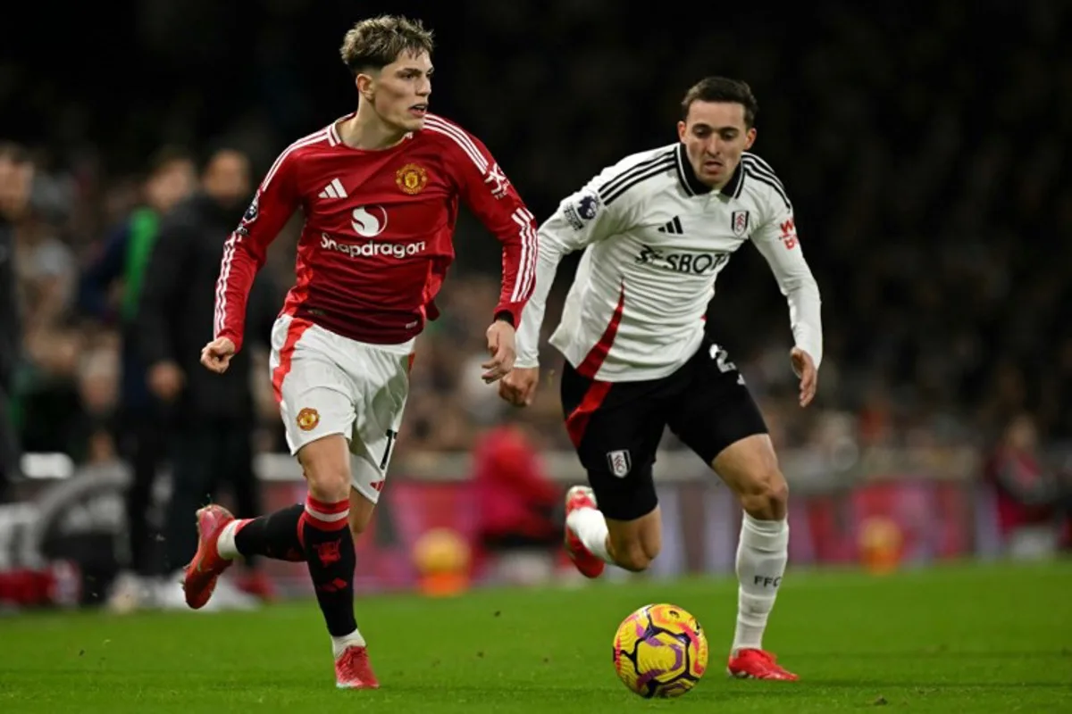 Manchester United's Argentinian midfielder #17 Alejandro Garnacho runs with the ball from Fulham's Belgian defender #21 Timothy Castagne during the English Premier League football match between Fulham and Manchester United at Craven Cottage in London on January 26, 2025.  Glyn KIRK / AFP