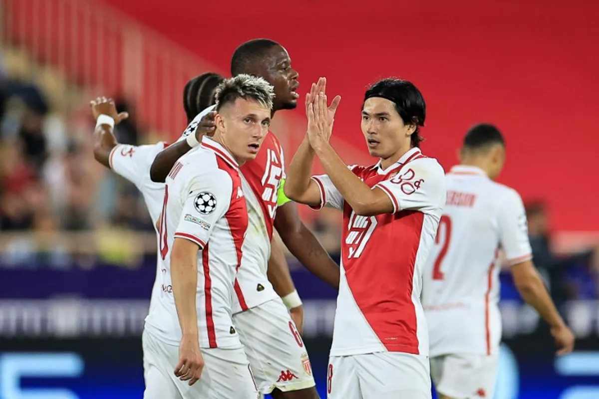 Monaco's Japanese forward #18 Takumi Minamino (R) celebrates with teammates after scoring his team's fourth goal  during the UEFA Champions League, League phase - Matchday 3, football match between AS Monaco and FK Crvena Zvezda (Red Star Belgrade) at the Louis II Stadium in Monaco, on October 22, 2024.   Valery HACHE / AFP