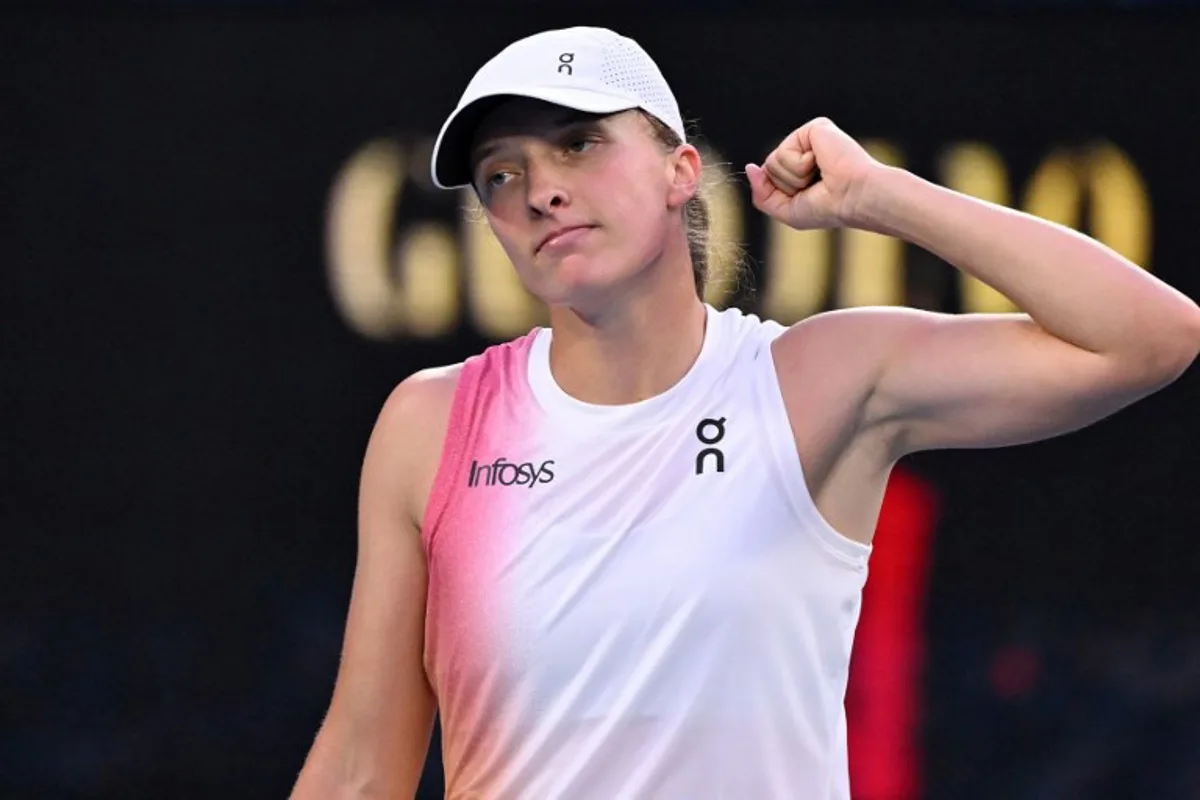 Poland's Iga Swiatek celebrates victory over Germany's Eva Lys after their women's singles match on day nine of the Australian Open tennis tournament in Melbourne on January 20, 2025.  WILLIAM WEST / AFP