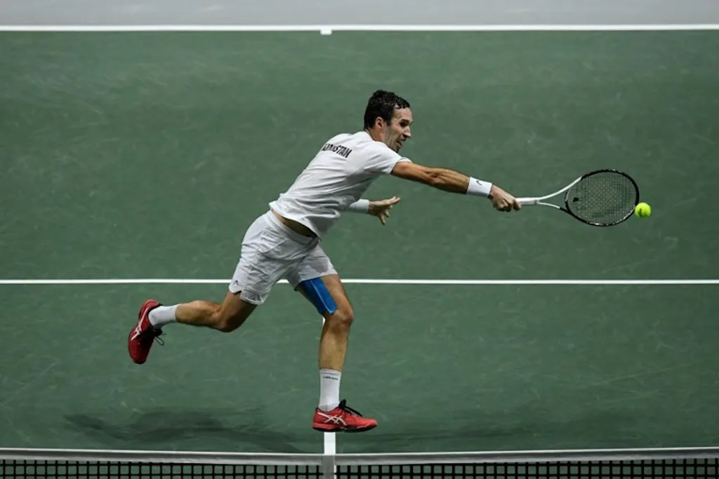 Kazakhstan's Mikhail Kukushkin returns the ball to Serbia's Miomir Kecmanovic during the men's singles quarter-final tennis match between Serbia and Kazakhstan of the Davis Cup tennis tournament at the Madrid arena in Madrid on December 1, 2021. OSCAR DEL POZO / AFP