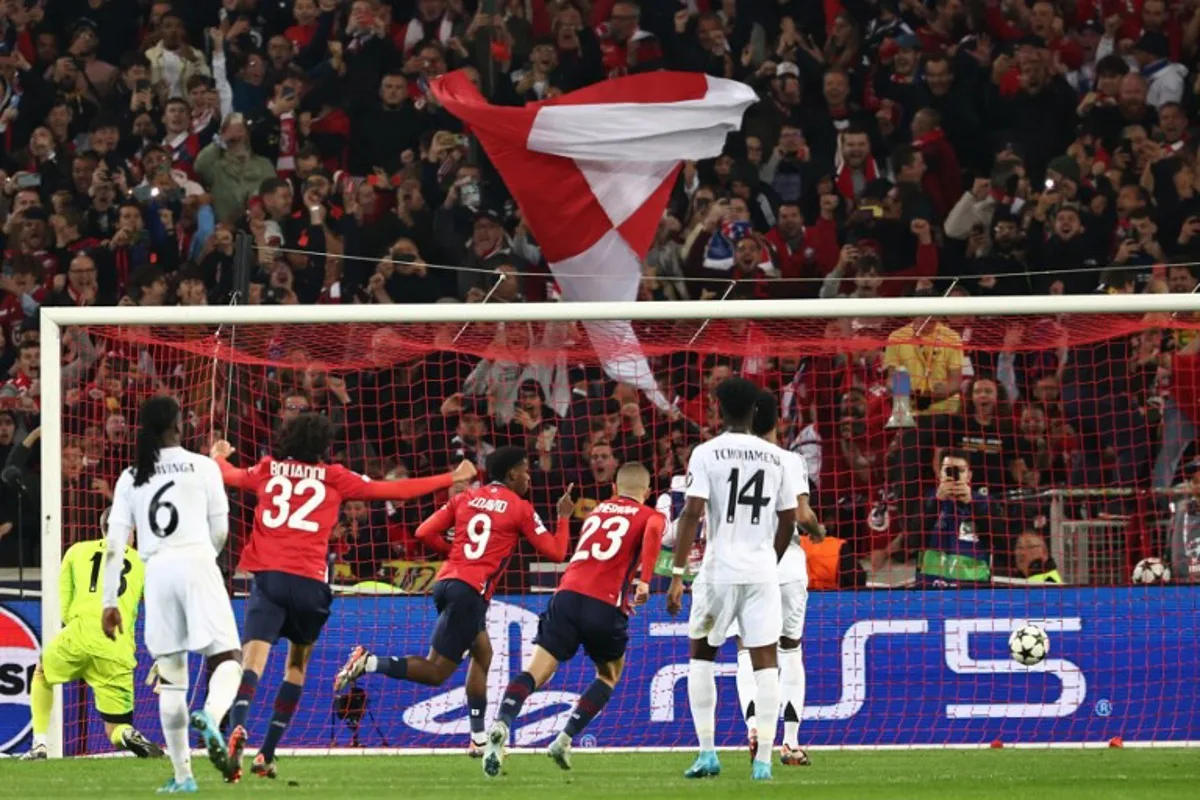 Lille's Canadian forward #09 Jonathan David celebrates after scoring a penalty goal during the UEFA Champions League football match between Lille LOSC and Real Madrid at the Pierre Mauroy Stadium in Villeneuve-d'Ascq, northern France, on October 2, 2024.  Sameer AL-DOUMY / AFP