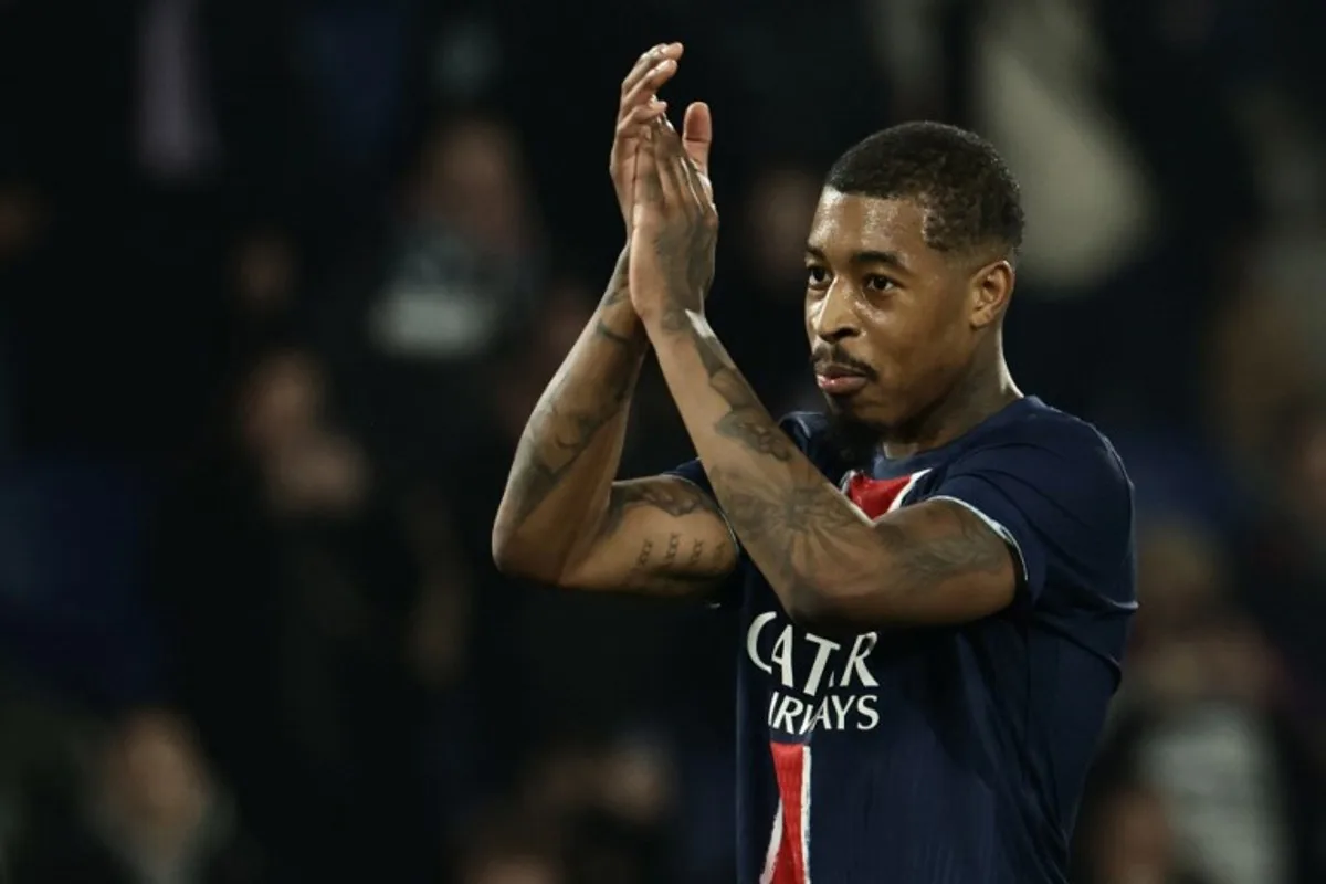 Paris Saint-Germain's French defender #03 Presnel Kimpembe celebrates PSG's victory at the end of the UEFA Champions League knockout phase play-off 2nd leg football match between Paris Saint-Germain (FRA) and Brest (FRA) at the Parc des Princes stadium in Paris on February 19, 2025. Thibaud MORITZ / AFP