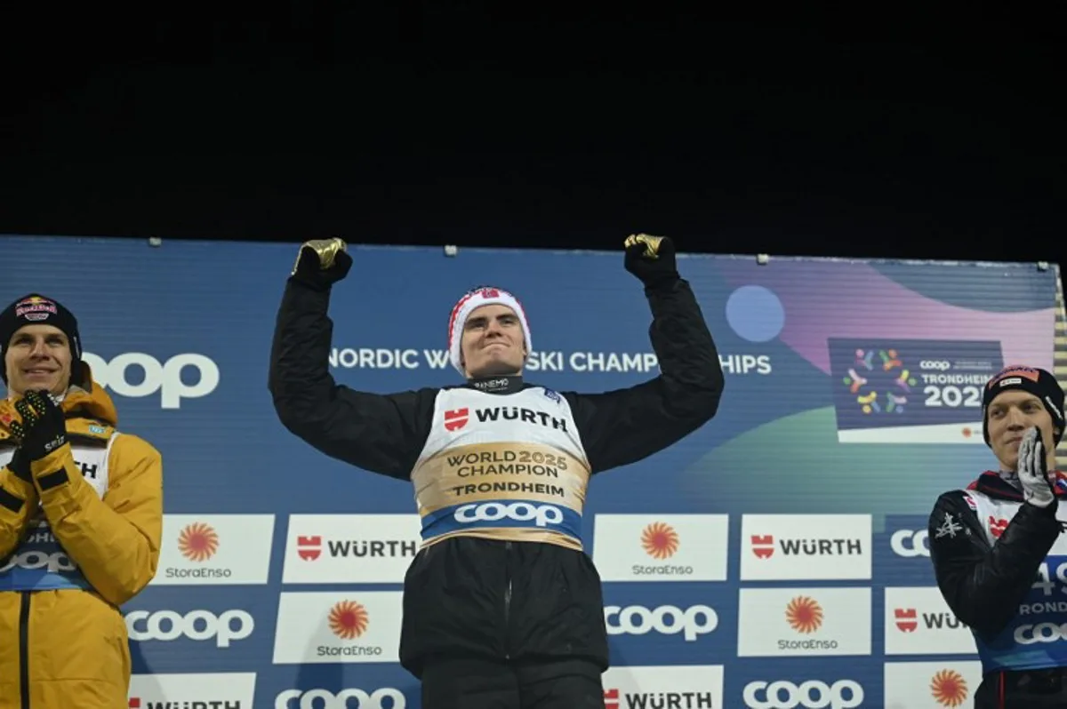 (L-R) Second placed Germany's Andreas Wellinger, winner Norway's Marius Lindvik and Austria's Jan Hoerl celebrate on the podium after the men's normal Hill HS102 event at the FIS Ski Jumping World Championships in Trondheim, Norway on March 2 2025. Jonathan NACKSTRAND / AFP