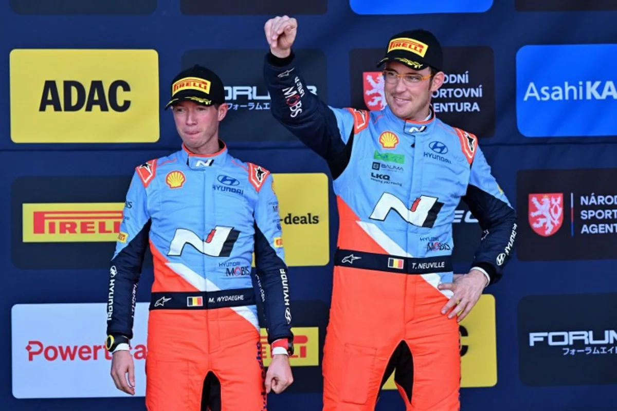 Third placed Belgium's driver Thierry Neuville (R) and co-driver Martijn Wydaeghe celebrate on the podium after the WRC Central European Rally 2023 in Breitenberg near Passau, southern Germany on October 20, 2024.    KERSTIN JOENSSON / AFP