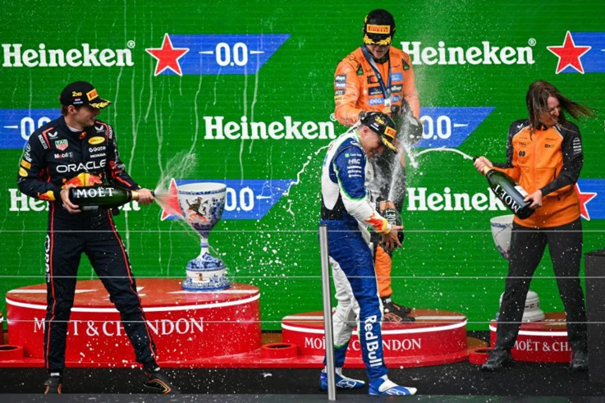 Second-placed Red Bull Racing's Dutch driver Max Verstappen, winner McLaren's Australian driver Oscar Piastri and third-placed RB's French driver Isack Hadjar celebrate on the podium following the Formula One Dutch Grand Prix at The Circuit Zandvoort, western Netherlands, on August 31, 2025. NICOLAS TUCAT / AFP